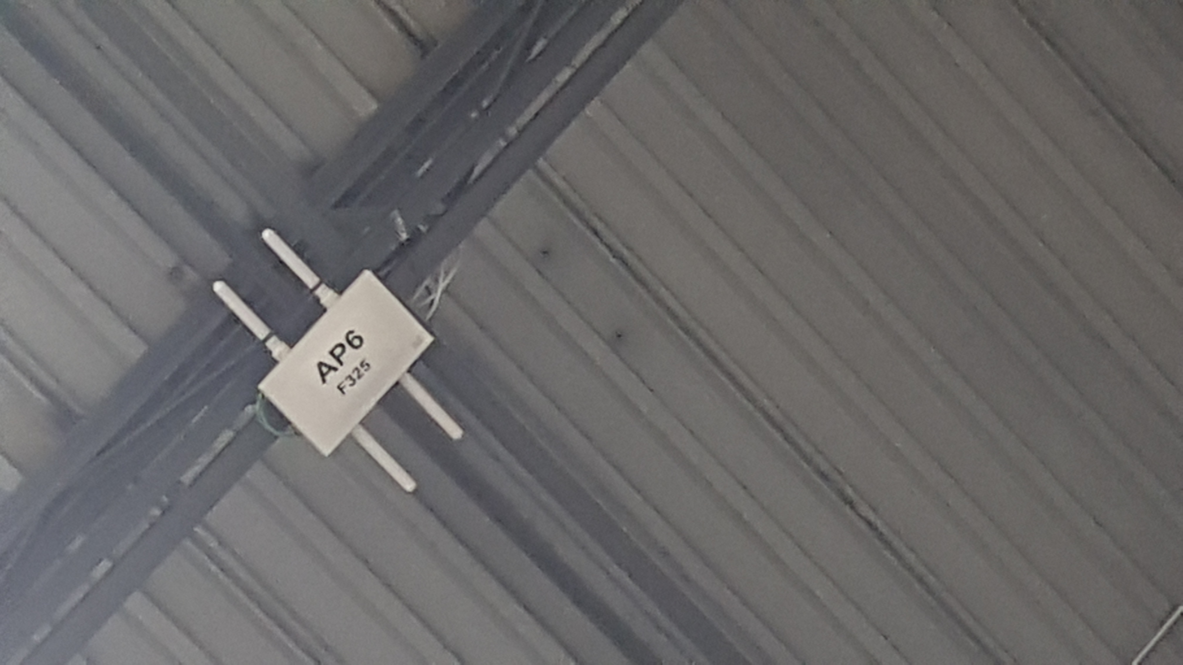 Wireless access point installed on ceiling — office Wi-Fi deployment
